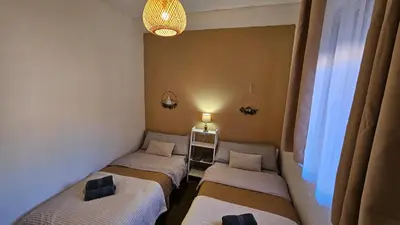 a row of beds in a room with a window at Casa Rural Torás Piscina, BBQ, Chimenea y WiFi 600Mb in Torás