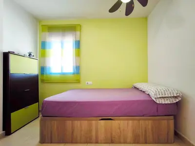 a bedroom with a bed with a purple mattress at Apartamento con terraza en Playa Grau de Moncofa in Moncófar