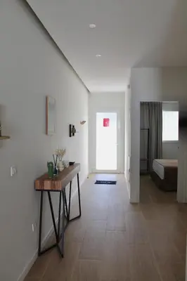 a large white room with a table and a bed at Maresia Zarco in Valencia