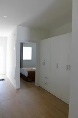 a white room with a bed and a window at Maresia Zarco in Valencia
