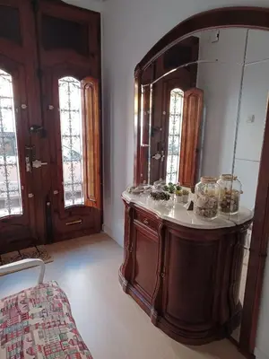 a bathroom with a wooden vanity and a large mirror at Lorea Puerto in Puerto de Sagunto