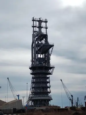 a large metal structure with cranes in the background at Lorea Puerto in Puerto de Sagunto