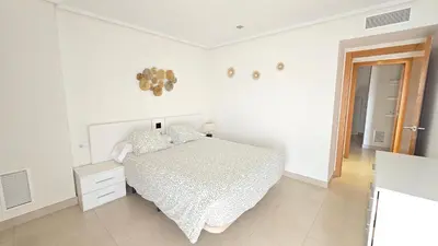 a white bedroom with a bed and a mirror at BEACH VALENCIA LUXURY D9-28 Apartment with terrace and sea views with two rooms in Valencia