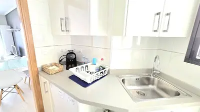 a white kitchen with a sink and a counter at BEACH VALENCIA LUXURY D9-28 Apartment with terrace and sea views with two rooms in Valencia