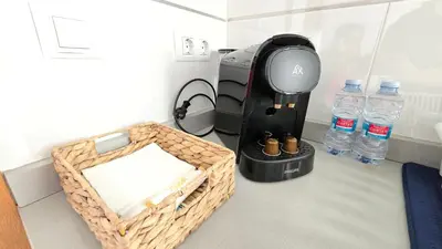 a coffee maker and a basket of water bottles at BEACH VALENCIA LUXURY D9-28 Apartment with terrace and sea views with two rooms in Valencia