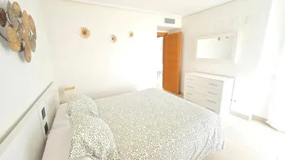 a white bedroom with a bed and a window at BEACH VALENCIA LUXURY D9-28 Apartment with terrace and sea views with two rooms in Valencia