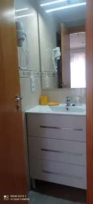a bathroom with a sink and a mirror at Apartamento Cullera Playa in Cullera