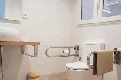 a bathroom with a toilet and a sink at Loft Familiar: Paz y Conexión Ideal en Valencia in Valencia