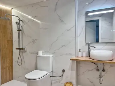 a white bathroom with a toilet and a sink at Loft Familiar: Paz y Conexión Ideal en Valencia in Valencia