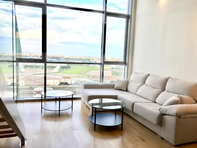 a living room with a couch and two tables at Panoramic Suites II By VALENCIAFLATS EU in Valencia