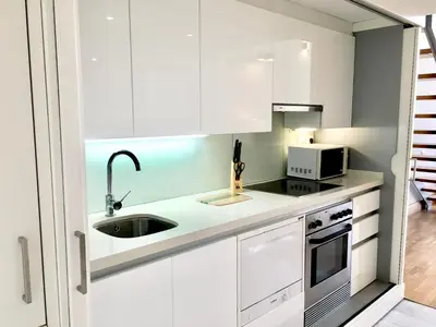 a white kitchen with a sink and a microwave at Panoramic Suites II By VALENCIAFLATS EU in Valencia