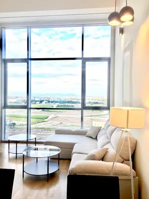 a living room with a couch and a large window at Panoramic Suites II By VALENCIAFLATS EU in Valencia
