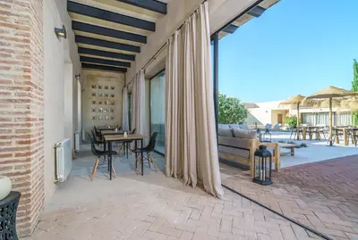 a patio with a table and chairs and a couch at Alqueria de Vilches in Cullera