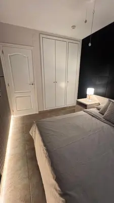 a bedroom with a bed and a table with a lamp at Apartamento en Canet De Berenguer Playa - Valencia in Valencia