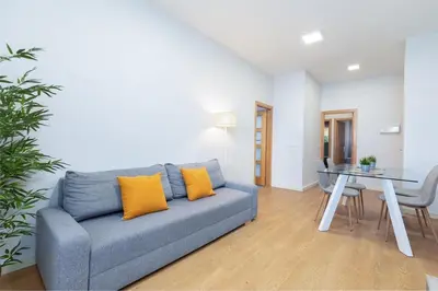 a living room with a blue couch and a table at Beachside Apartment Valencia Ideal for Digital Nomads in Valencia