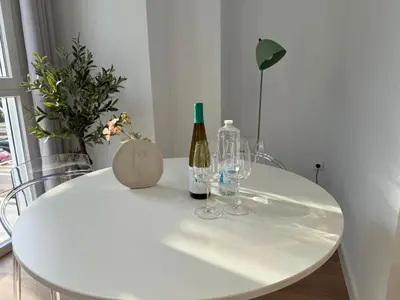 a white table with two bottles and glasses on it at Design and style next to Playa de Valencia in Valencia