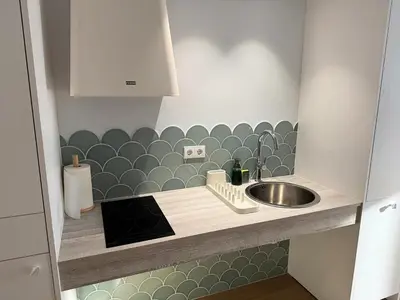 a small kitchen with a sink and a counter at Design and style next to Playa de Valencia in Valencia
