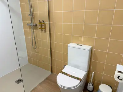 a bathroom with a toilet and a shower at Design and style next to Playa de Valencia in Valencia