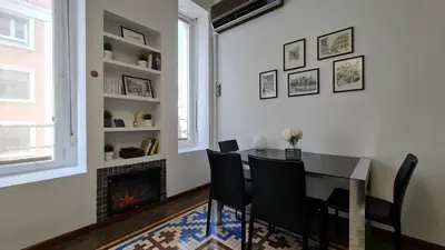 a dining room with a table and chairs and a fireplace at The Plaza Residence in Valencia