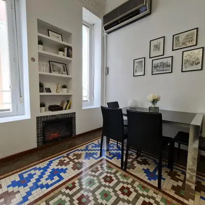 a dining room with a table and chairs and a fireplace at The Plaza Residence in Valencia