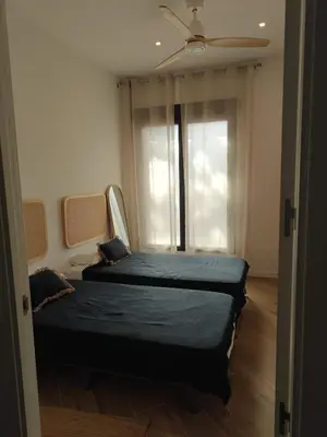 a bedroom with two beds in front of a window at Eliving - Apartment BioPark City Center & Airport in Valencia