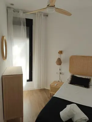 a bedroom with a bed and a ceiling fan at Eliving - Apartment BioPark City Center & Airport in Valencia