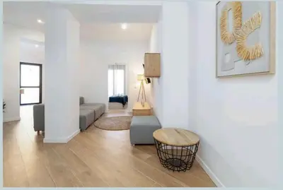 a living room with a couch and a table at Eliving - Apartment BioPark City Center & Airport in Valencia