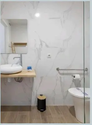 a bathroom with a toilet and a glass shower at Eliving - Apartment BioPark City Center & Airport in Valencia