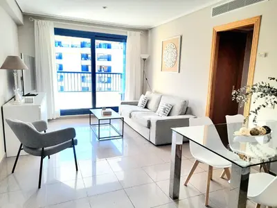 a living room with a couch and a table at BEACH VALENCIA LUXURY D15-21 Apartment with terrace and sea views with two rooms in Valencia