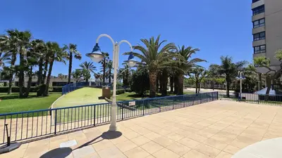 a street light with a fence and palm trees at BEACH VALENCIA LUXURY D15-21 Apartment with terrace and sea views with two rooms in Valencia