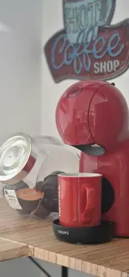 a red coffee maker sitting on top of a table at Calma mediterránea in Favareta
