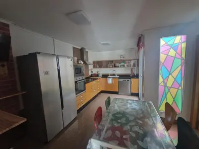 a kitchen with a table and a stained glass window at Calma mediterránea in Favareta