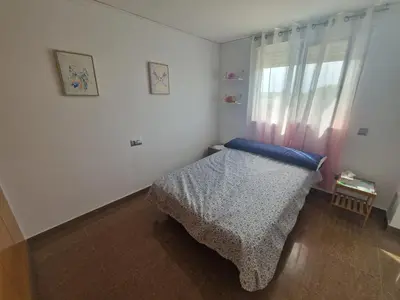 a small bedroom with a bed and a window at Calma mediterránea in Favareta