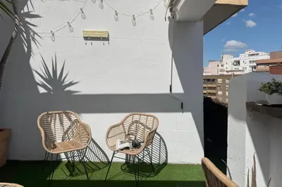 two chairs on a balcony with a basketball hoop on the wall at SingularStays Plaza Andújar in Valencia