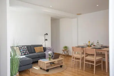 a living room with a couch and a table at SingularStays Plaza Andújar in Valencia