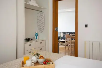 a tray of food on a table in a bedroom at SingularStays Plaza Andújar in Valencia