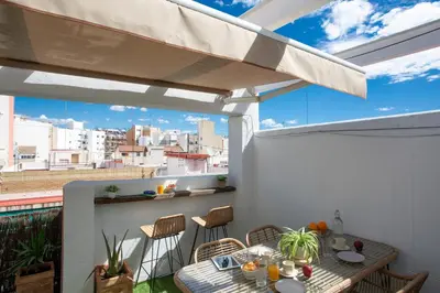a patio with a table and chairs on a balcony at SingularStays Plaza Andújar in Valencia