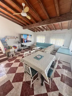 a living room with a table and a couch at Casa en la montaña con jacuzzi exterior y piscina in Alcántara de Júcar