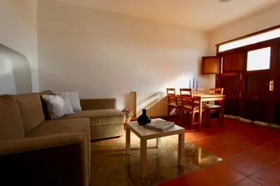 a living room with a couch and a table at Peaceful apartment in Peñalba in Peñalba