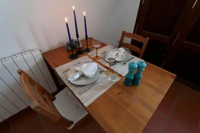a dining room table with candles and plates and chairs at Peaceful apartment in Peñalba in Peñalba
