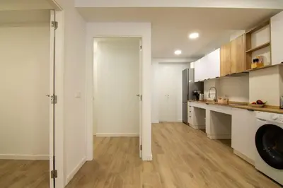 a kitchen with white cabinets and a washer at Casa Pedro Cabanes in Valencia