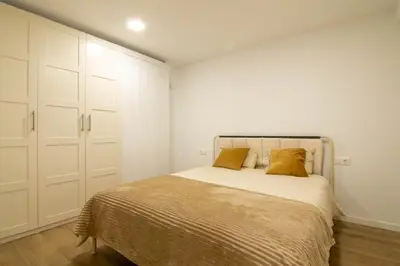 a bedroom with a bed with two pillows on it at Casa Pedro Cabanes in Valencia