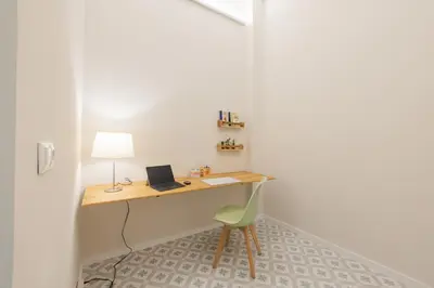 a room with a desk with a laptop and a chair at Marina Arts Lofts in Valencia