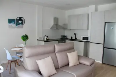 a living room with a couch and a kitchen at Arenisca Zarco in Valencia