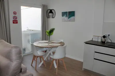 a small kitchen with a table and chairs in a room at Arenisca Zarco in Valencia