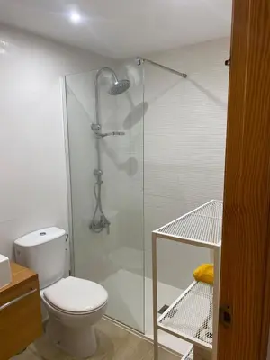 a bathroom with a toilet and a glass shower at Encantador apartamento con terraza en la Playa de Moncófar in Moncófar