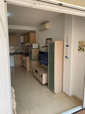 a kitchen with a large open door to a room at Encantador apartamento con terraza en la Playa de Moncófar in Moncófar