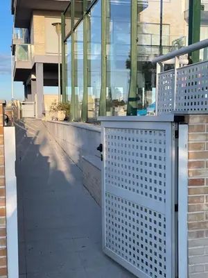 a white metal gate in front of a building at kalma in Moncófar