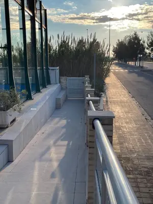 a row of benches on a sidewalk next to a building at kalma in Moncófar