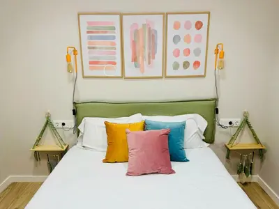 a bedroom with a bed with colorful pillows on it at Modern Apartment with Style near Center in Valencia